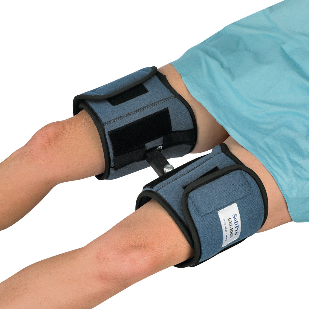 A person wearing the OCSI SoftPro HKO (Hip/Knee Orthosis) on both legs. The orthosis is blue with black straps and connectors.