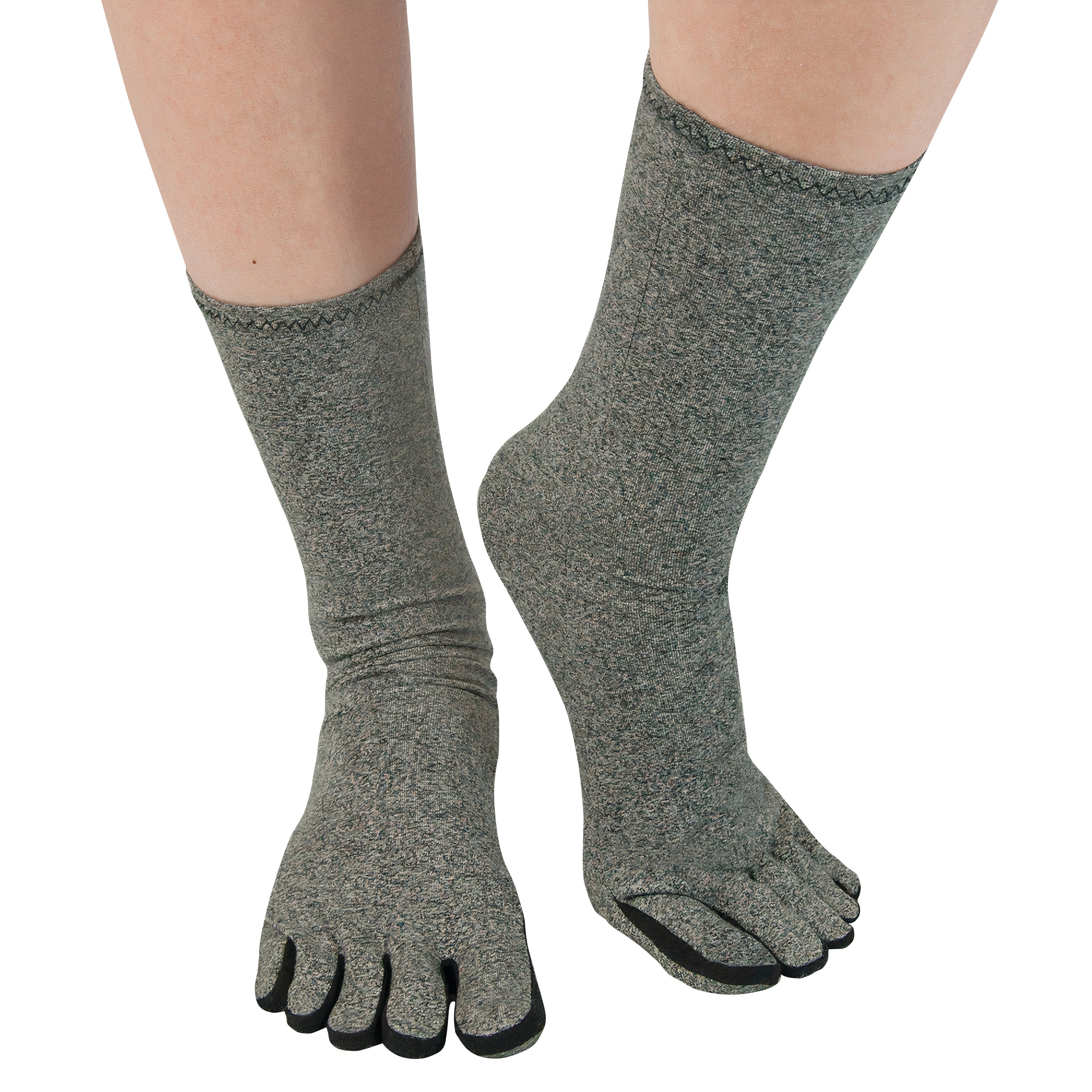 A person wearing Brownmed IMAK Compression Arthritis Socks in gray, designed with individual toe compartments and black accents.