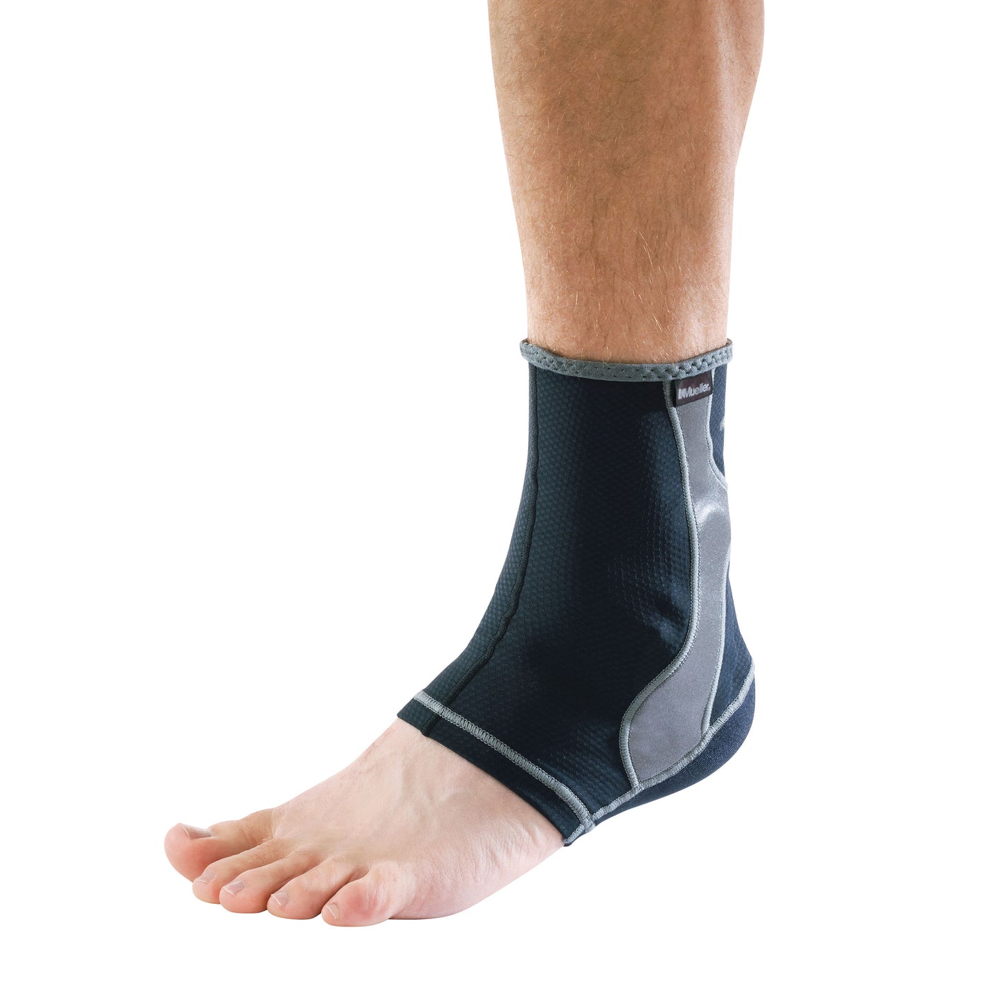 A bare foot wearing a Mueller Hg80 Ankle Support, featuring a black and gray design for stabilization.