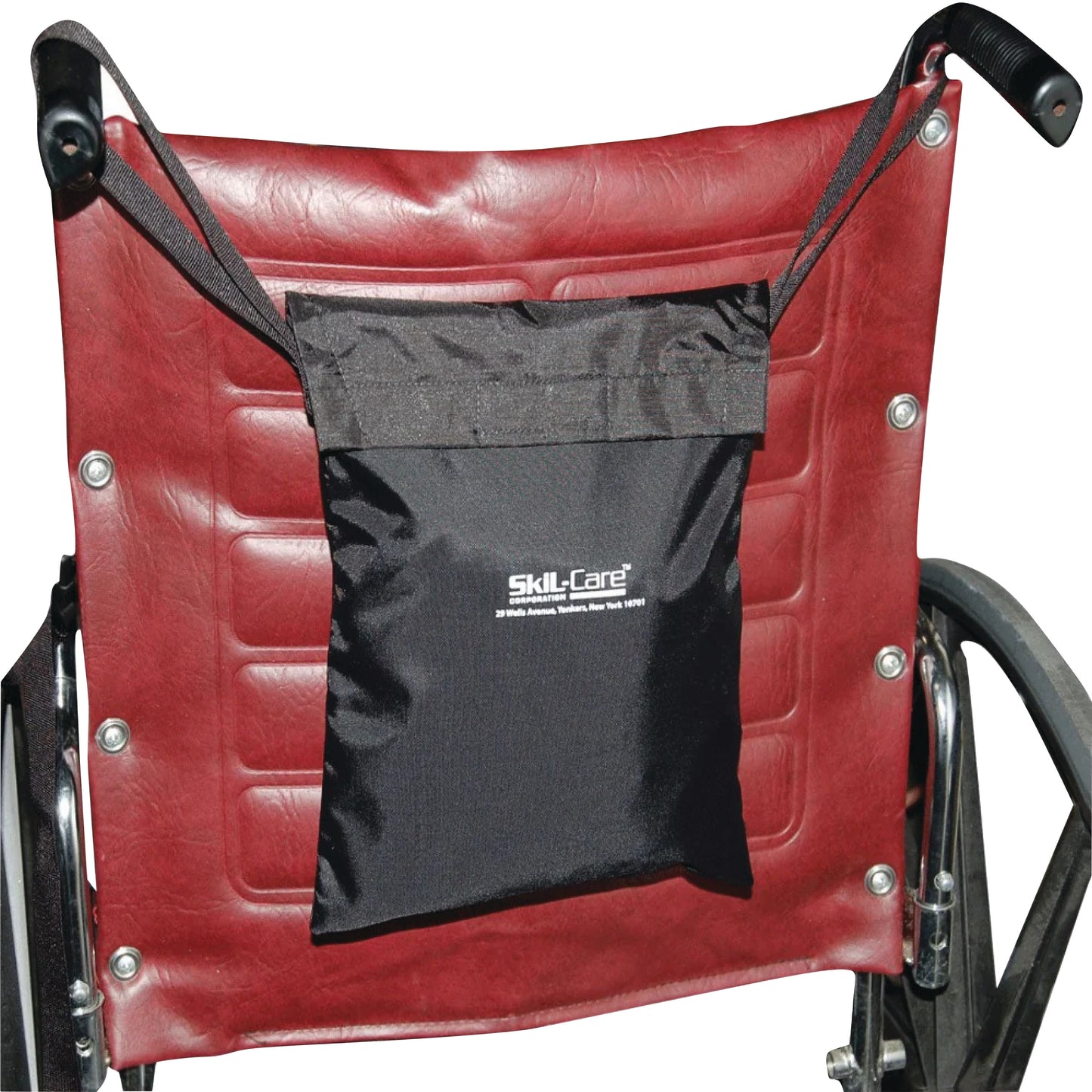 A wheelchair features a attached SkiL-Care Rain Cape with Carry Case, secured on a red backrest with straps.