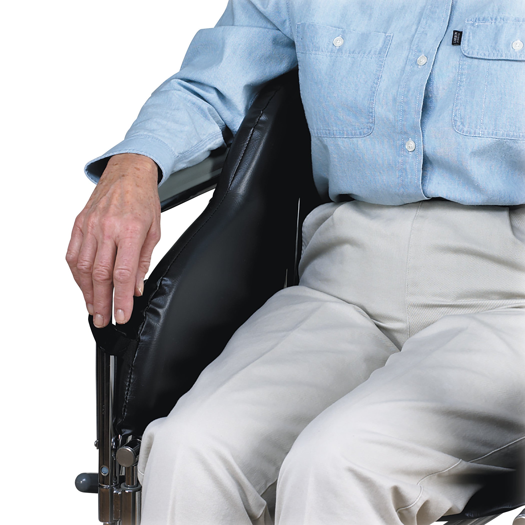 A person in a blue shirt and white pants using a SkiL-Care Snug Support on a wheelchair for added comfort and stability.