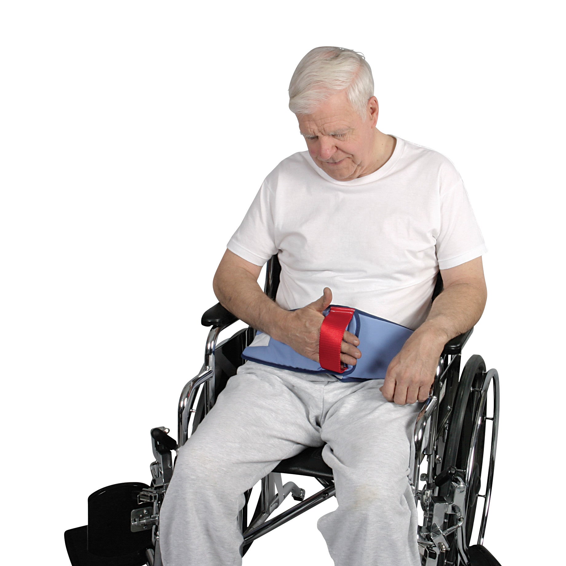 An elderly man sits in a wheelchair using the AliMed Restraint-Free Cushioned Lap Belt, which is blue with a red handle.