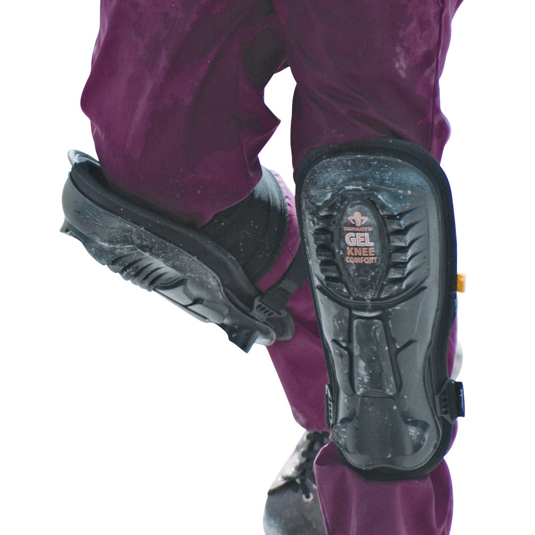 A person wearing Impacto Gel Knee/Shin Pads over purple pants, shown from the side with black boots on a white background.