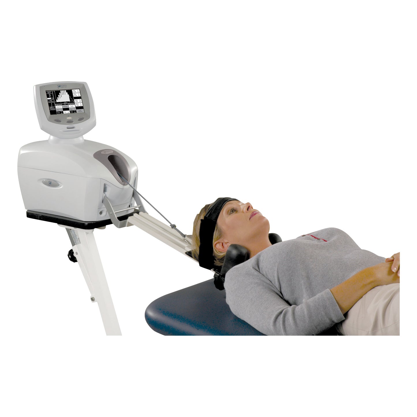 A woman uses the Saunders Cervical Traction Device, lying on a table with a neck strap connected to the device.