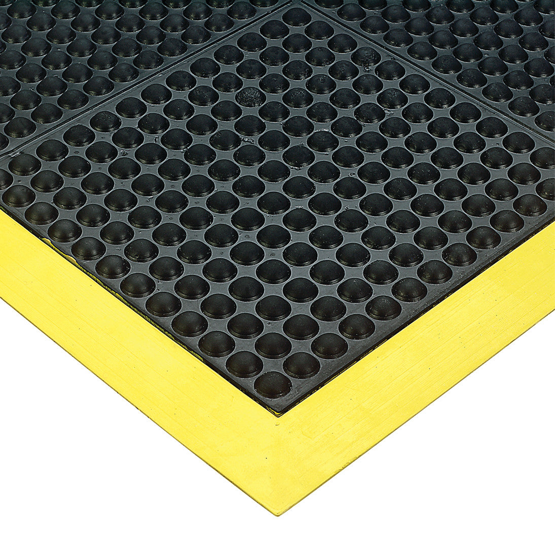 Close-up of a Wearwell Ortho Stand Anti-Fatigue Mat with black textured surface and yellow beveled edges.