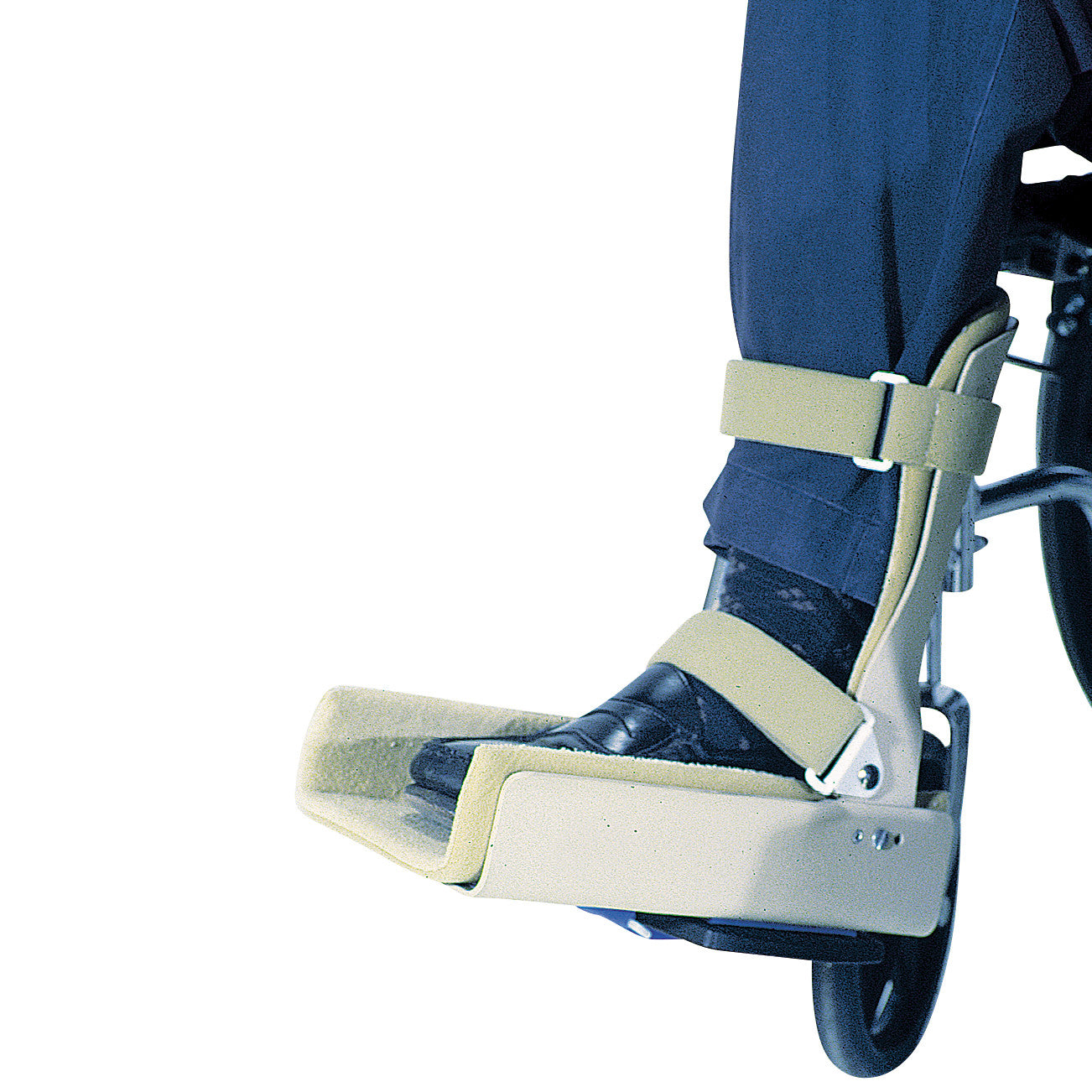 AliMed Wheelchair Foot Support on a leg with straps securing a foot, attached to a wheelchair.