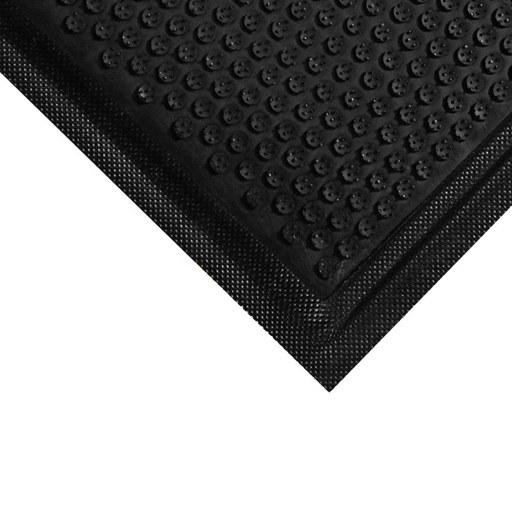 Close-up of a black DuraComfort Anti-Fatigue Mat with a textured, non-slip surface and rounded raised bumps for comfort.