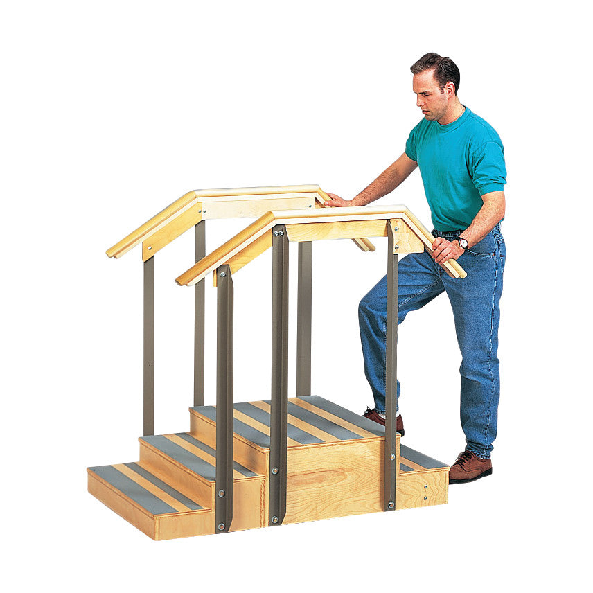 A person uses the Clinton Two-Sided Mini Staircase, featuring three wooden steps and metal handrails on both sides.