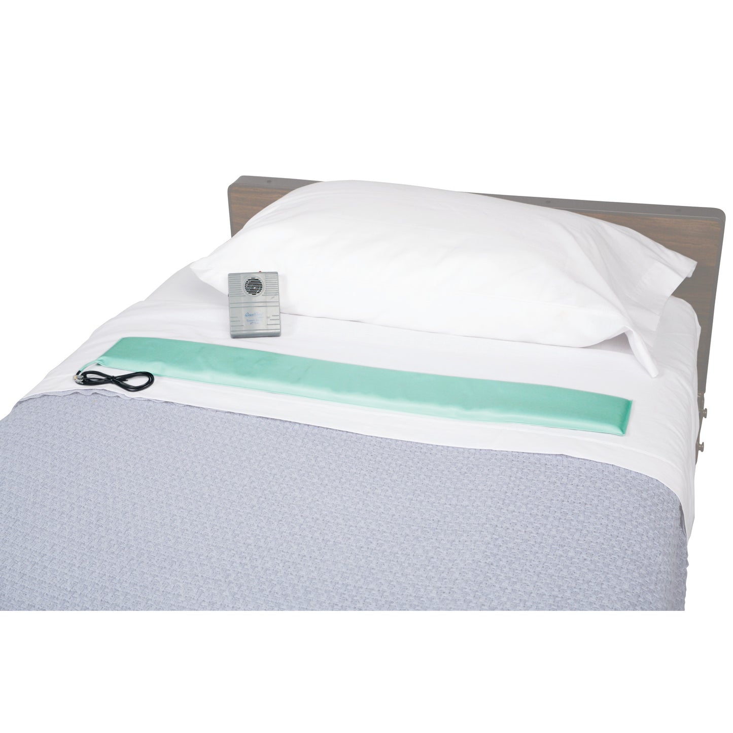 A Replacement Bed Sensor Pad for AliMed Standard Alarm is placed on a bed with a white sheet, white pillow, and gray blanket.