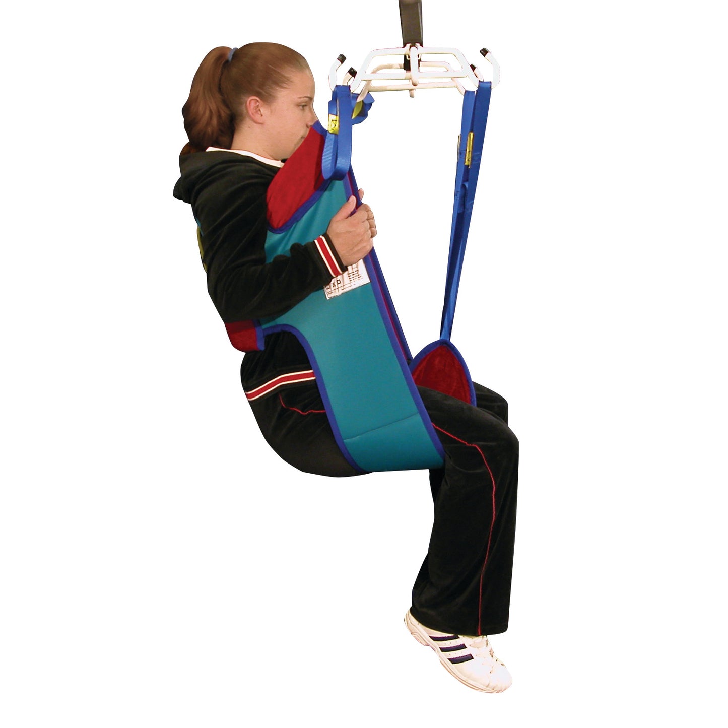 A person sits in a Bestcare Sani-Sling Patient Sling, designed for lifting and transferring. The sling is blue and red.