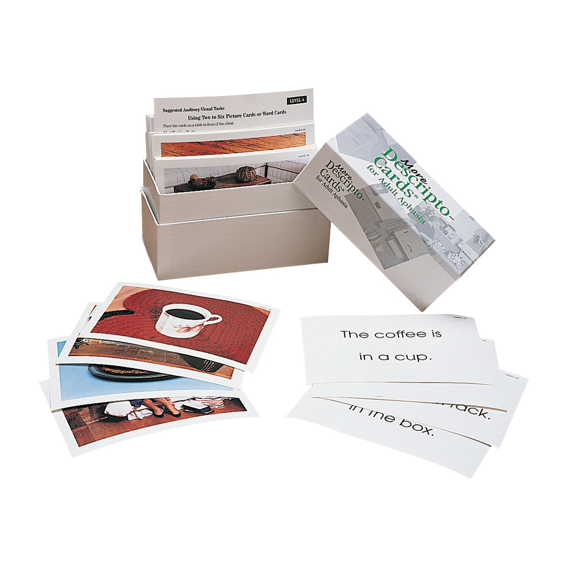 Box of "More Descripto-Cards for Adult Aphasia" includes various picture and word cards for therapy, scattered around the box.