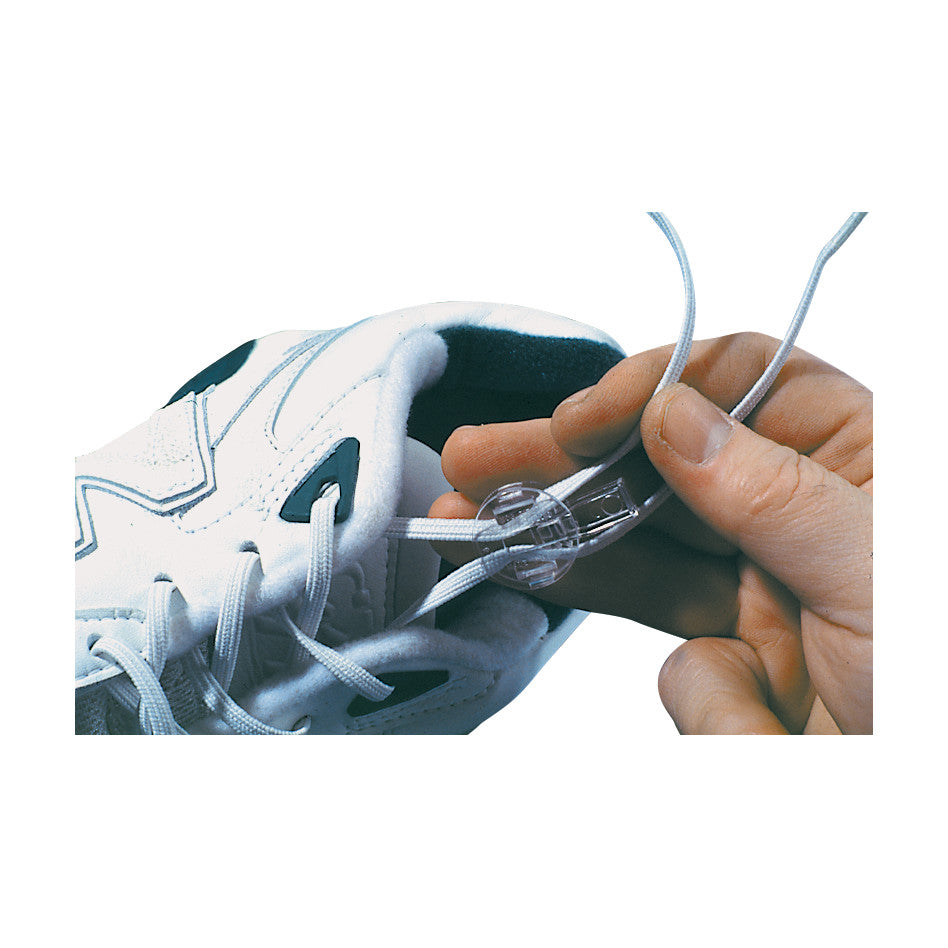 A white sneaker with No-Tie Stretch Shoe Laces secured by a plastic clip, held by a hand.
