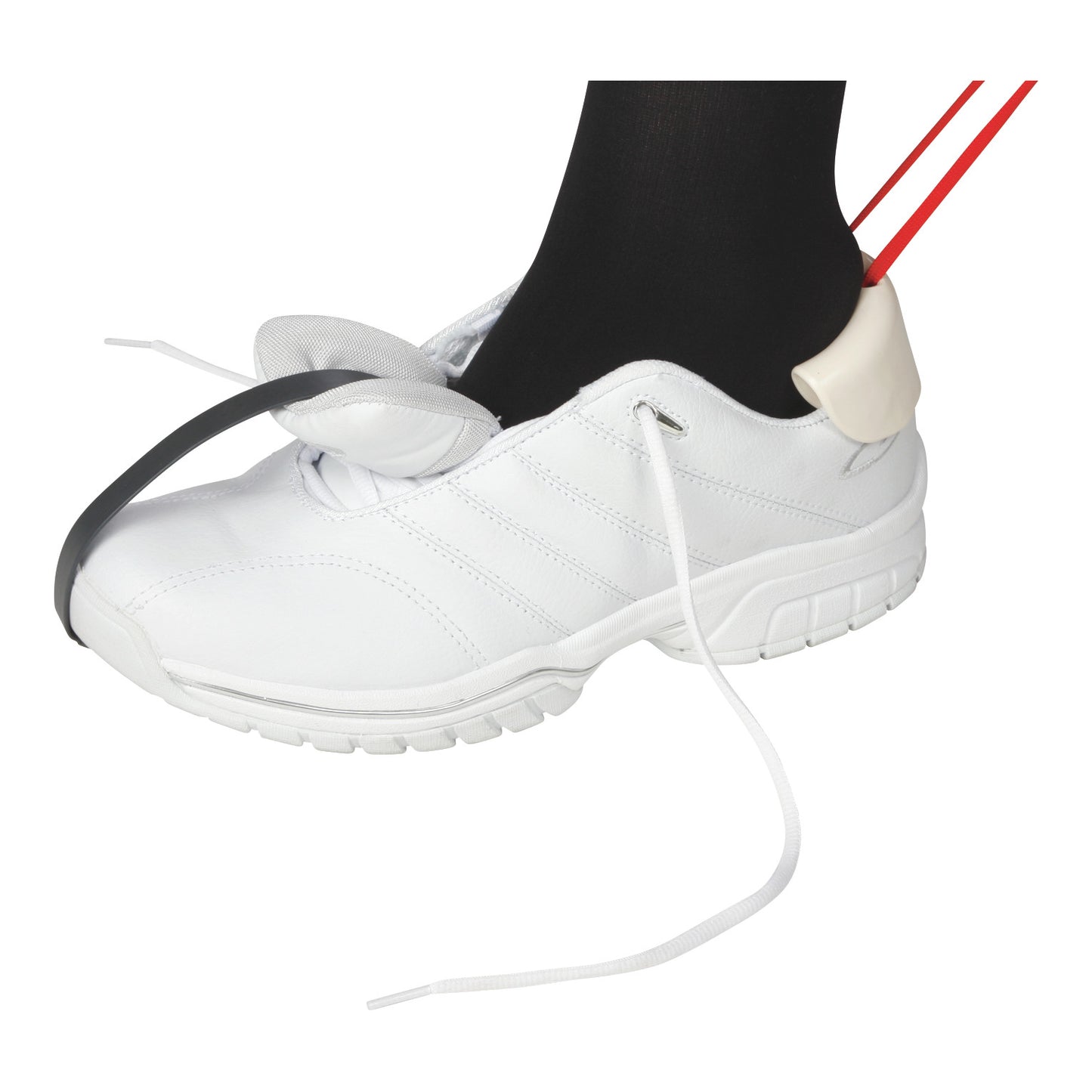 A foot wearing a white shoe with loose laces is helped by the AliMed Shoe Aid tool for easier wearing and adjusting.