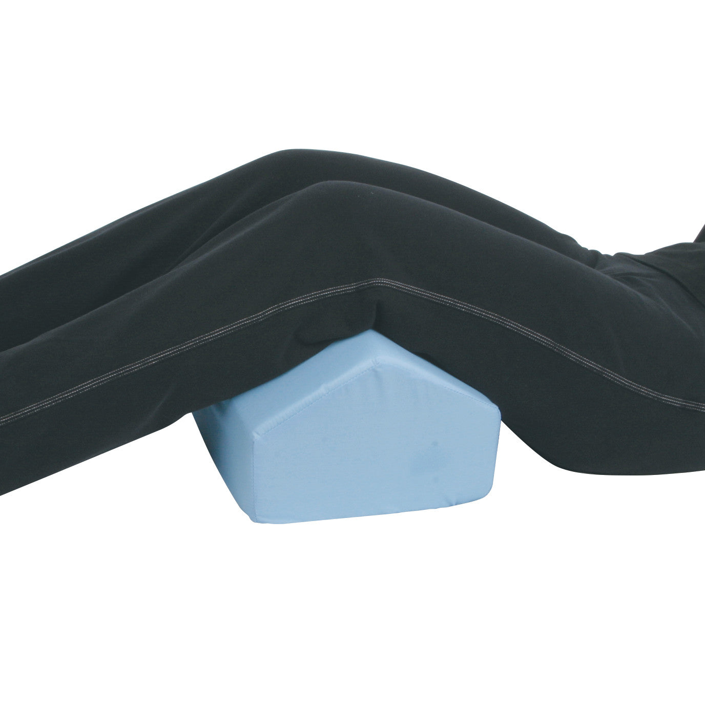 A person reclines with their knees resting on a light blue Bariatric Knee-Pillo, used for support and comfort.