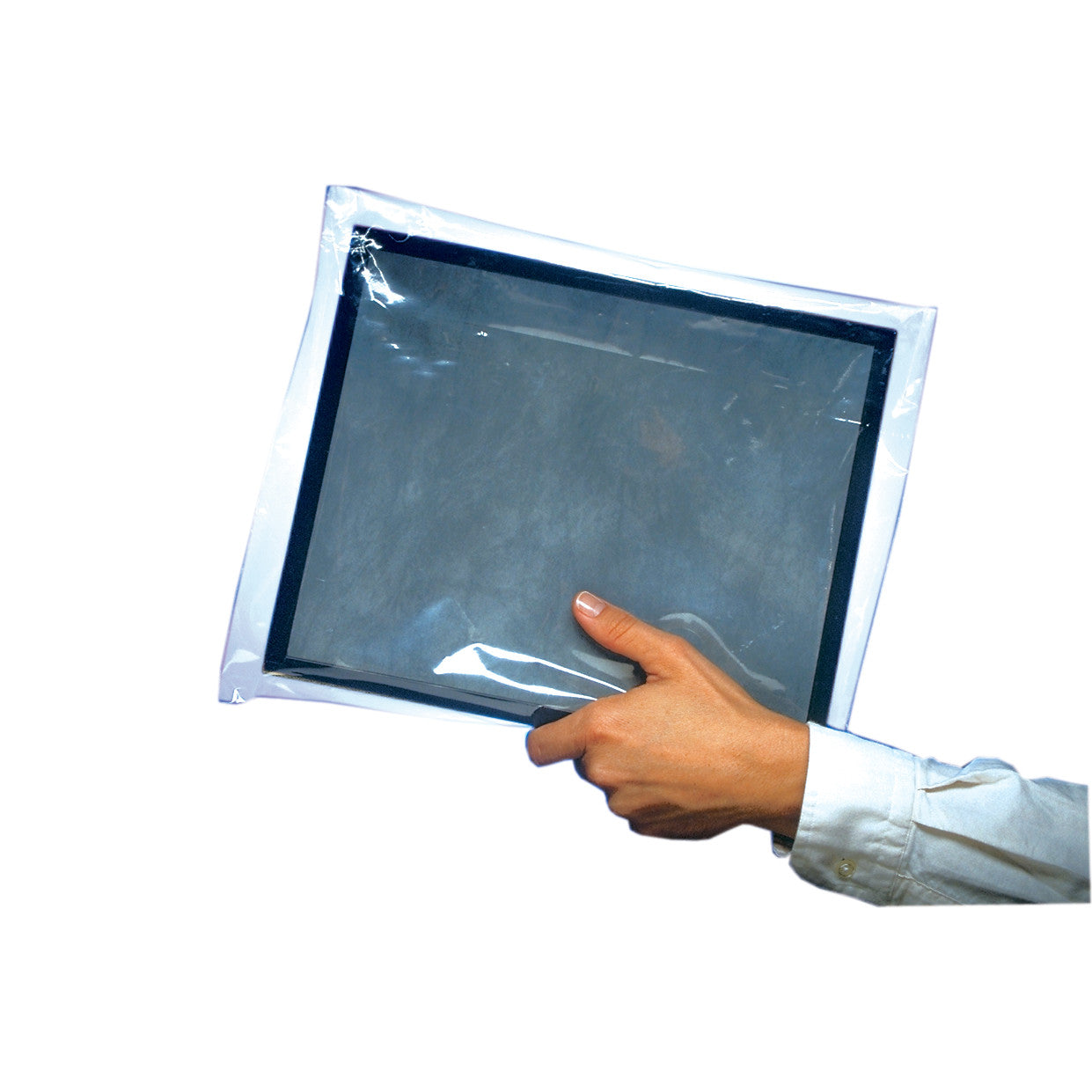 A hand holds a Protex-Ray Clear Film Disposable Cassette Cover, showing its transparent plastic material and rectangular shape.