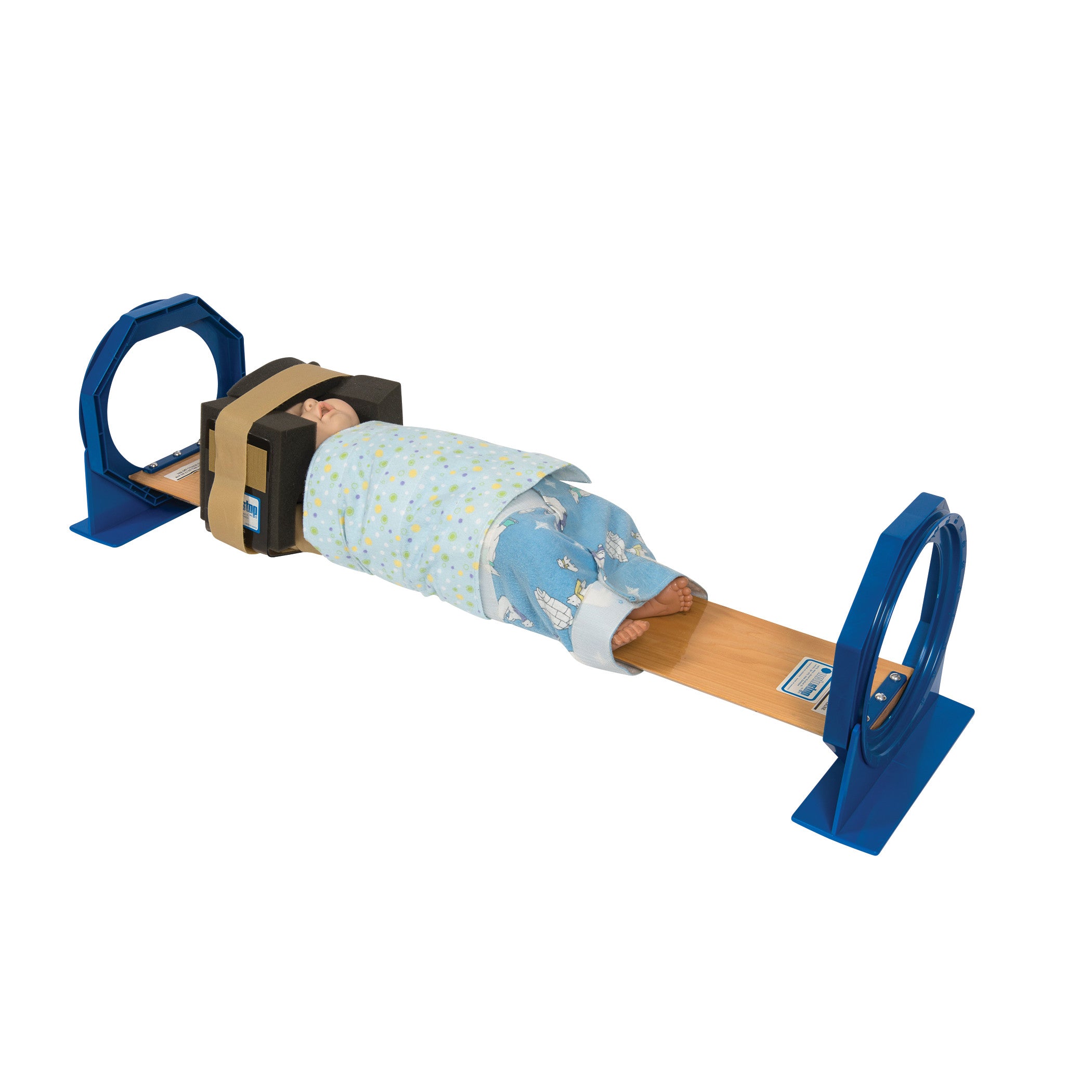 A baby mannequin is secured in a Universal Octopaque Pediatric Positioner, used for medical imaging alignment.