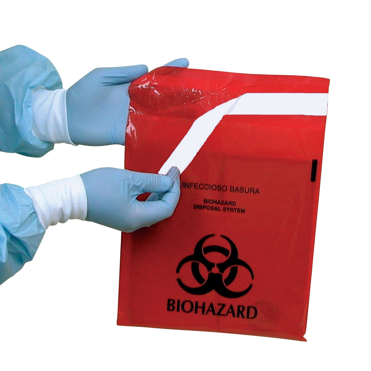 Two gloved hands hold a Red Biohazard Waste Stick-On Bag with biohazard symbols and text in English and Spanish.