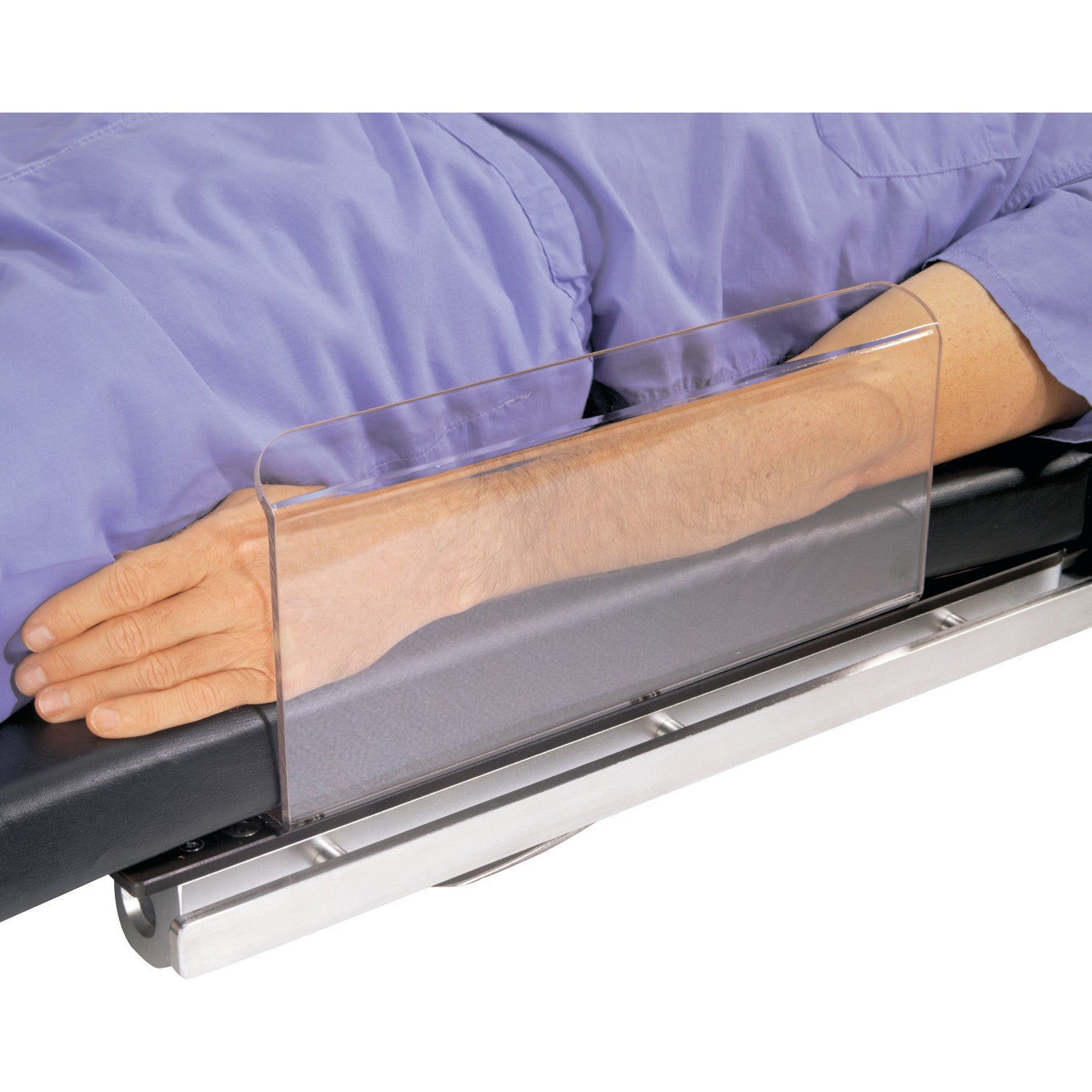 A person lying down with their arm protected by the Allen Arm Shield Pad, featuring a transparent panel attached to a bed.