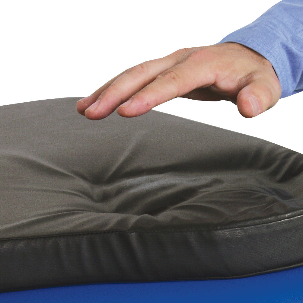 A hand hovers over a Replacement Pad for AliMed Major Procedure Hand Table, showing the cushion's indentation and softness.