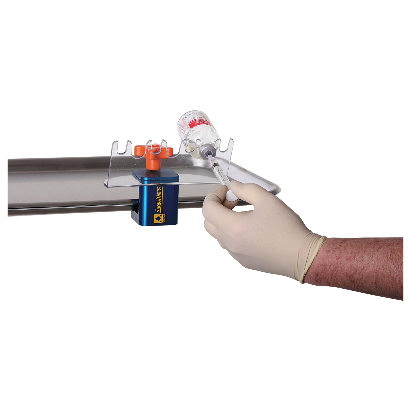A hand uses a syringe with the AliMed ACCU-DRAW Vial Holder, which secures a vial on a tabletop for easy extraction.