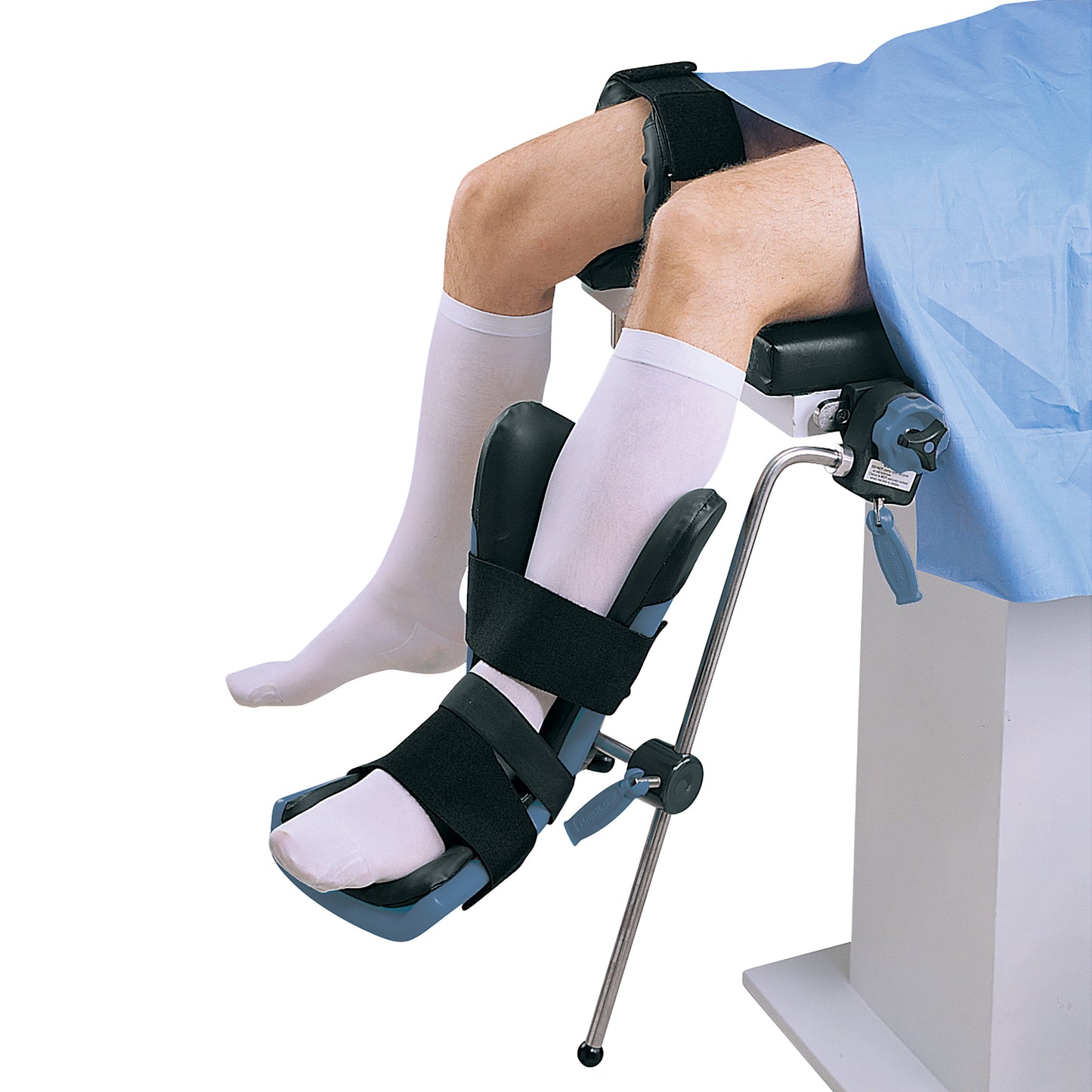 A person in white socks uses the Replacement Boot Pad for Allen Arthroscopic Well Leg Holder, secured to a medical table.