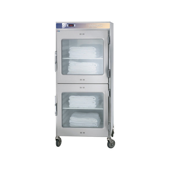 Pedigo Enthermics Blanket Warming Cabinet with Casters, featuring two glass doors, holds neatly stacked white blankets inside.