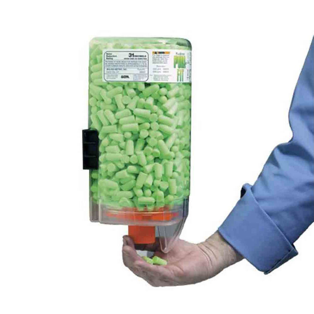 A person dispenses earplugs from a "Non-Magnetic Bulk Ear Plug Dispenser," filled with green earplugs, onto their hand.