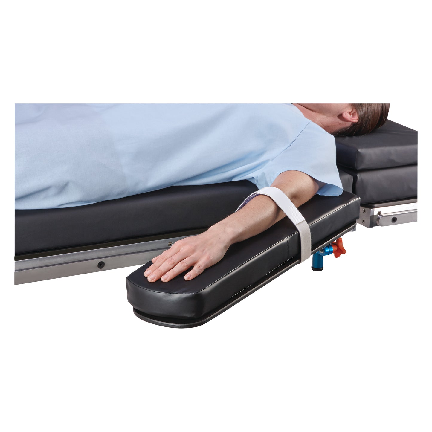 A person's arm rests on a cushioned surface secured with a Covidien Devon Single-Use Armboard Strap on a medical bed.