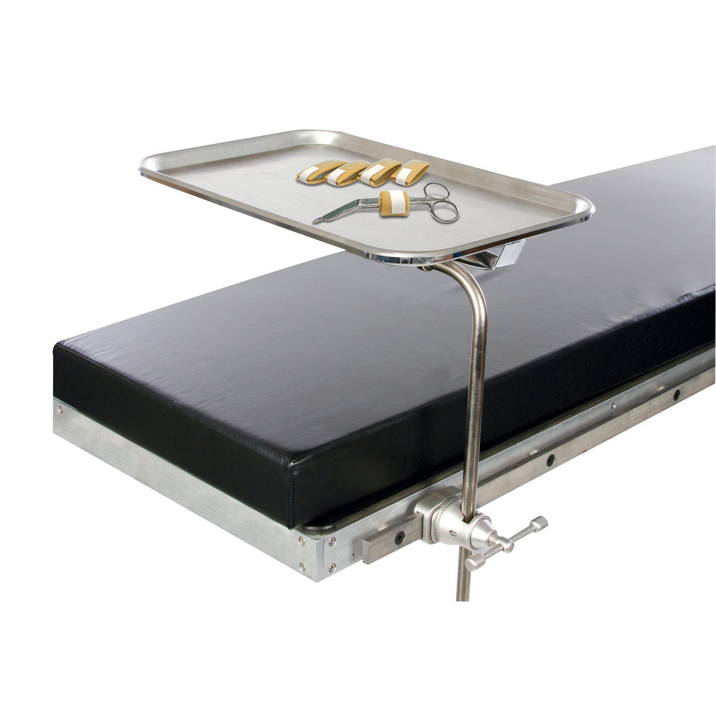 A metal tray attached to a black table holds the AliMed Instrument Band, scissors, and other tools, used in medical settings.