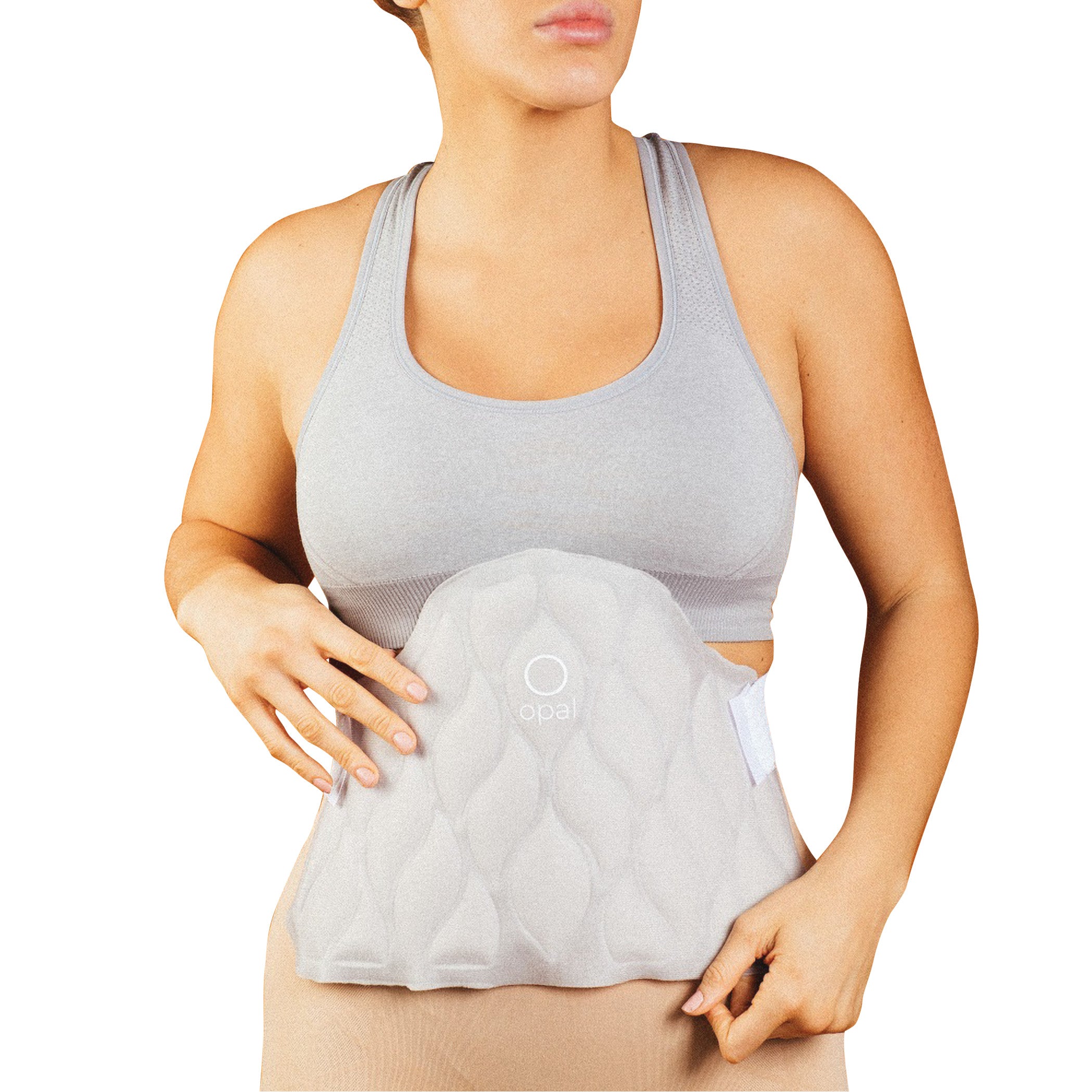 A person wearing the Xena Therapies Opal Cool One cooling pad on their abdomen, dressed in a gray sports bra and beige pants.