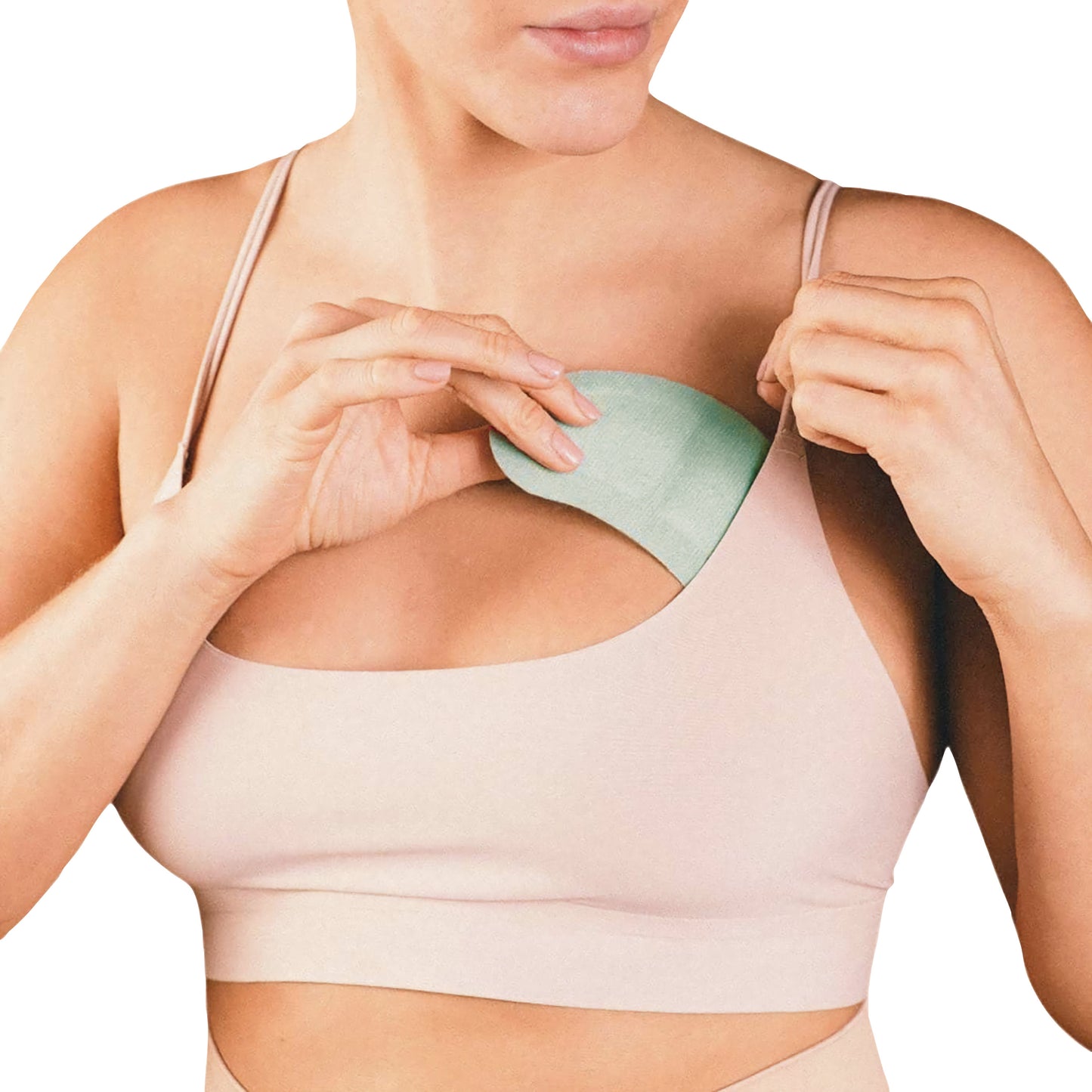 A person applies the Xena Therapies Opal Cool Gal Pals cooling pad to their chest while wearing a beige sports bra.