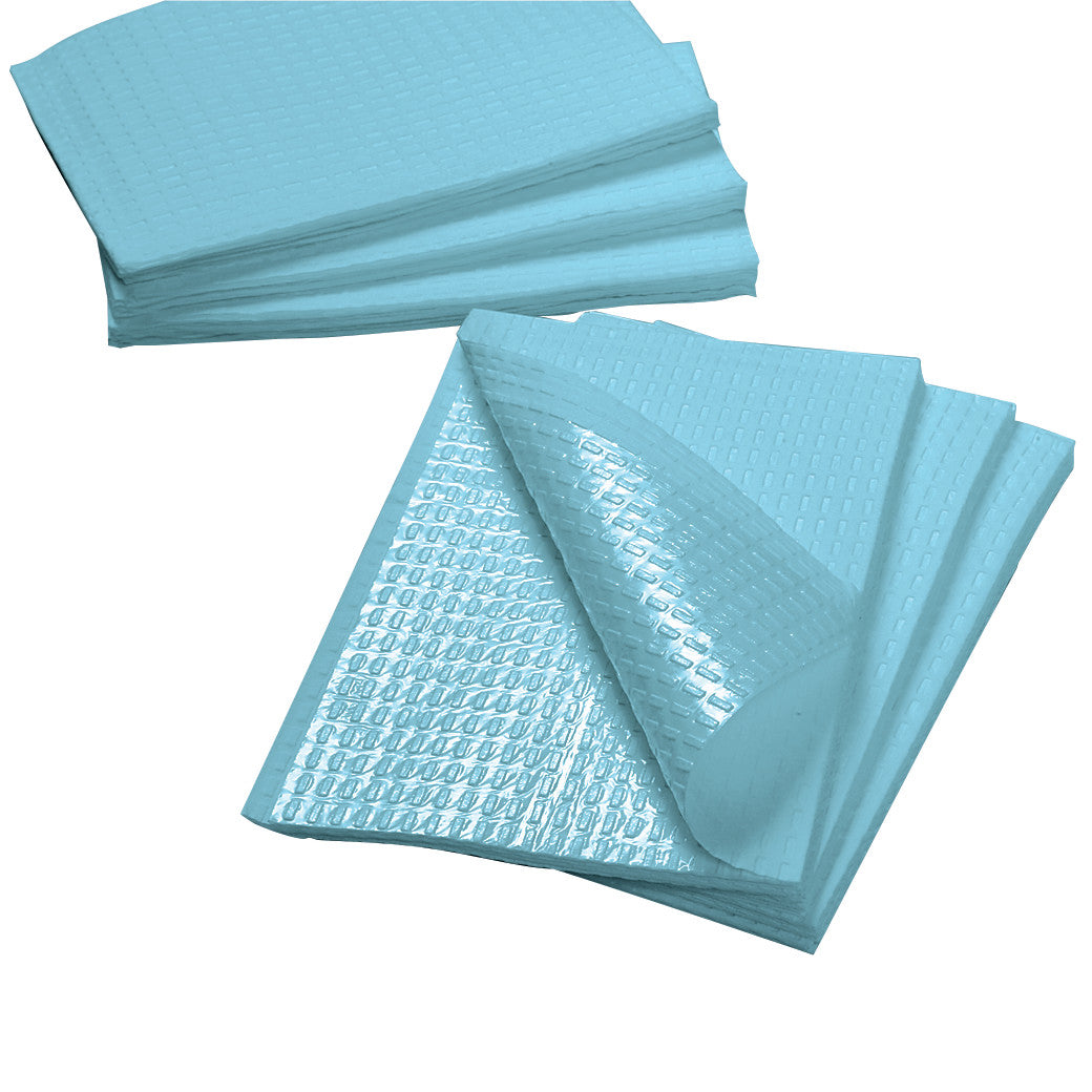 A stack of Tidi Polytowel sheets, light blue with a textured, shiny surface, partially folded to show layering detail.