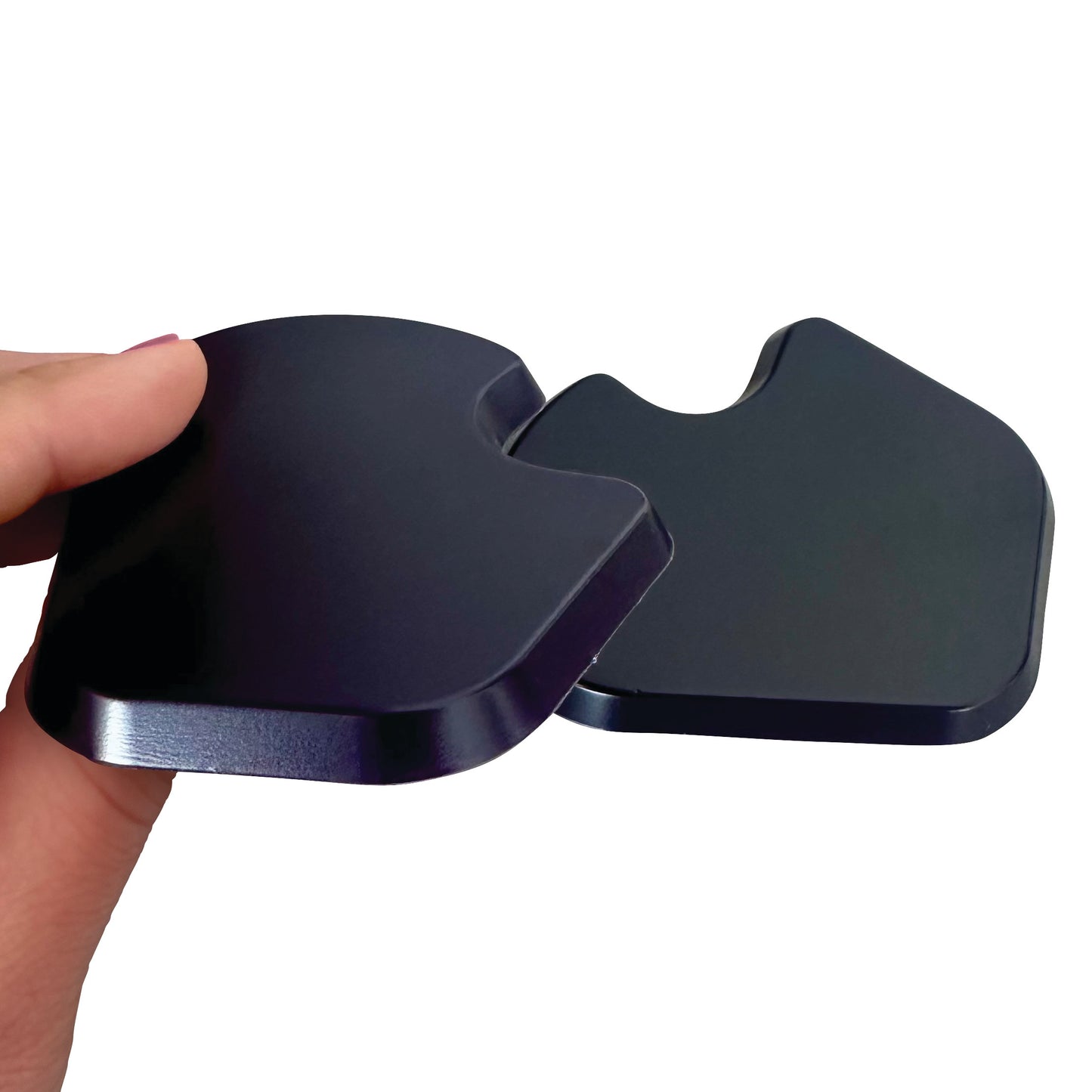 A hand holds a black Gel Dancer Met Pad, showing its smooth, curved design for foot cushioning.