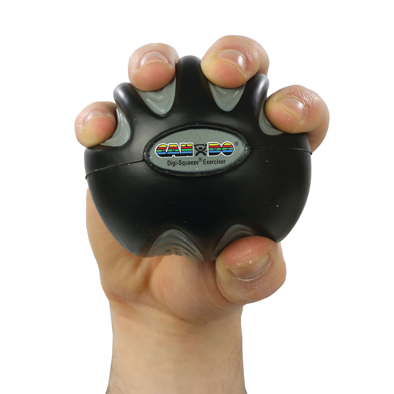 A hand grips a CanDo Digi-Squeeze Hand Exerciser, a black spherical tool for strengthening fingers and hands.
