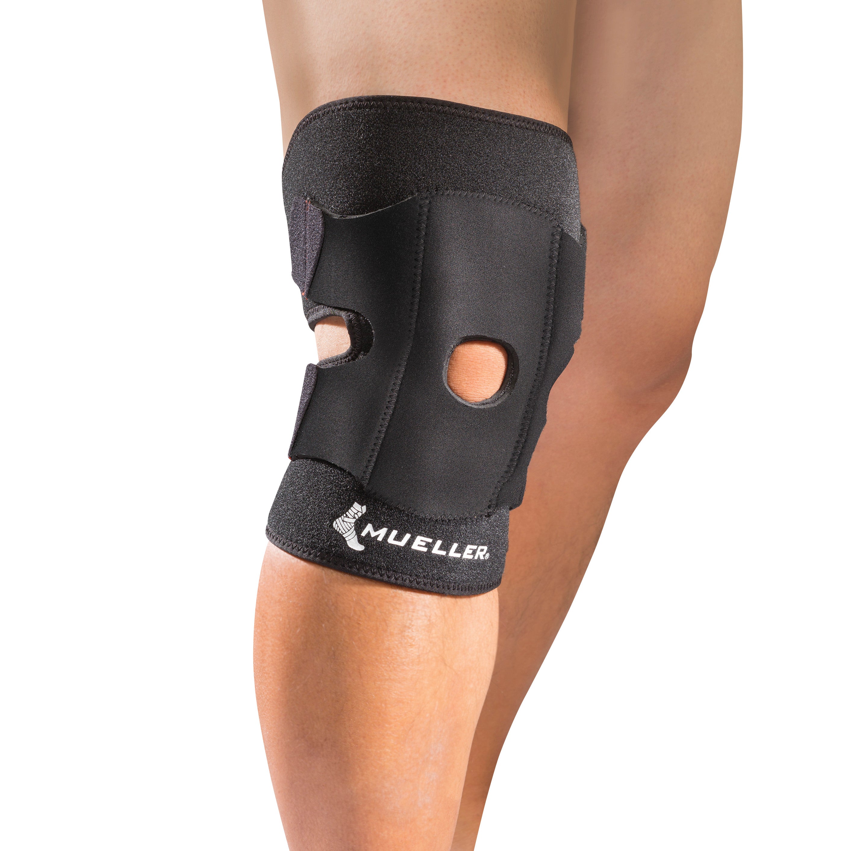 Person wearing a Mueller Adjustable Knee Support, a black brace with cutouts, providing knee stability and compression support.
