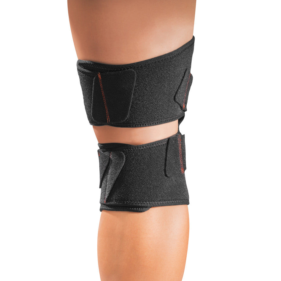 Person wearing a Mueller Adjustable Knee Support with two black straps with hook and loop closures above and below the knee.