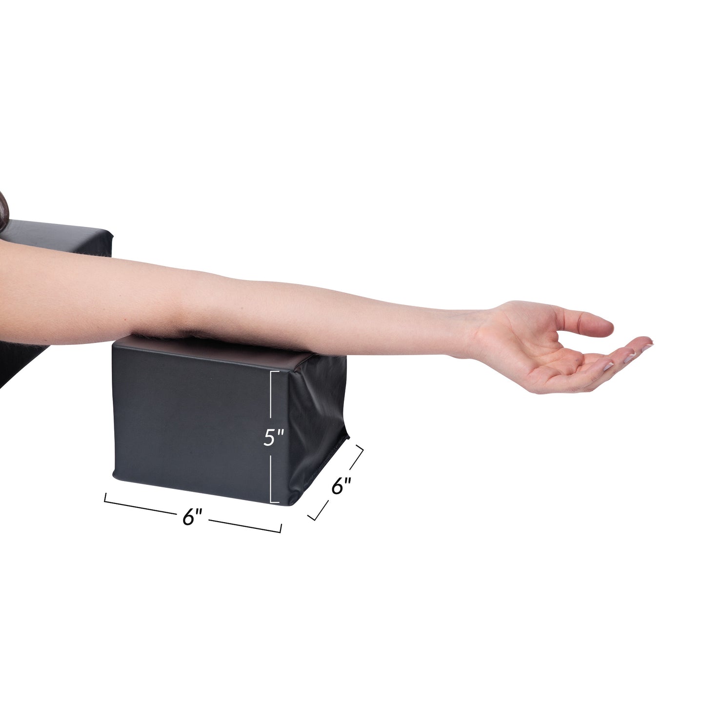 A person's arm rests on the AliMed Feldon Hand Prepper, a black, rectangular cushion measuring 6x6x5 inches.