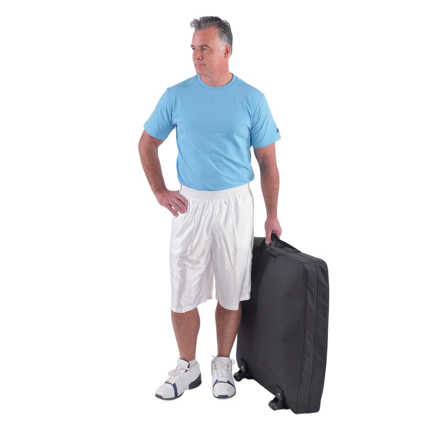 A man in a blue shirt and white shorts holds the wheeled carrying case for the Saunders Lumbar Traction Device.