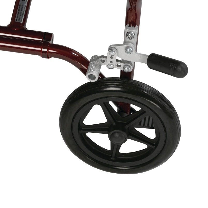 Close-up of the rear wheel and brake mechanism of the Drive Medical Fly-Lite Aluminum Transport Chair, featuring a red frame.