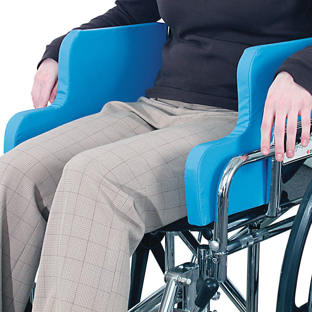 A person sitting in an AliMed Wheelchair Side Support with blue padding on the sides for added comfort and stability.