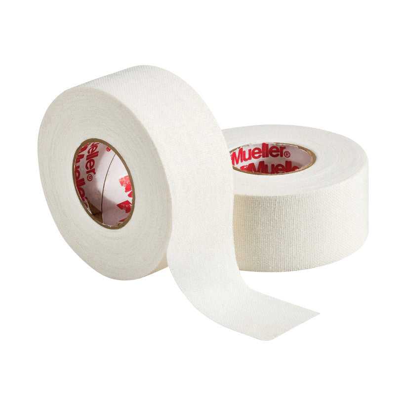 Two rolls of Mueller MTape Athletic Tape, one partially unrolled, white in color, with red branding visible inside the rolls.