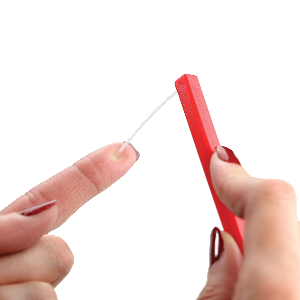 A person uses the Baseline Hand Monofilament Set, pressing a monofilament against a fingertip to test sensation.