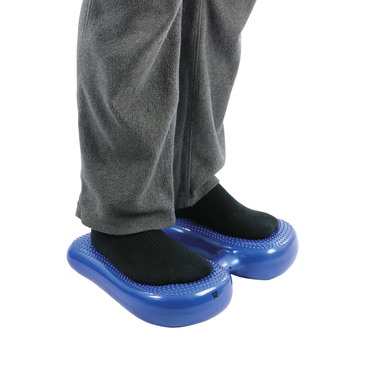 A person stands on blue CanDo Vestibular Steppers while wearing black socks and grey pants.