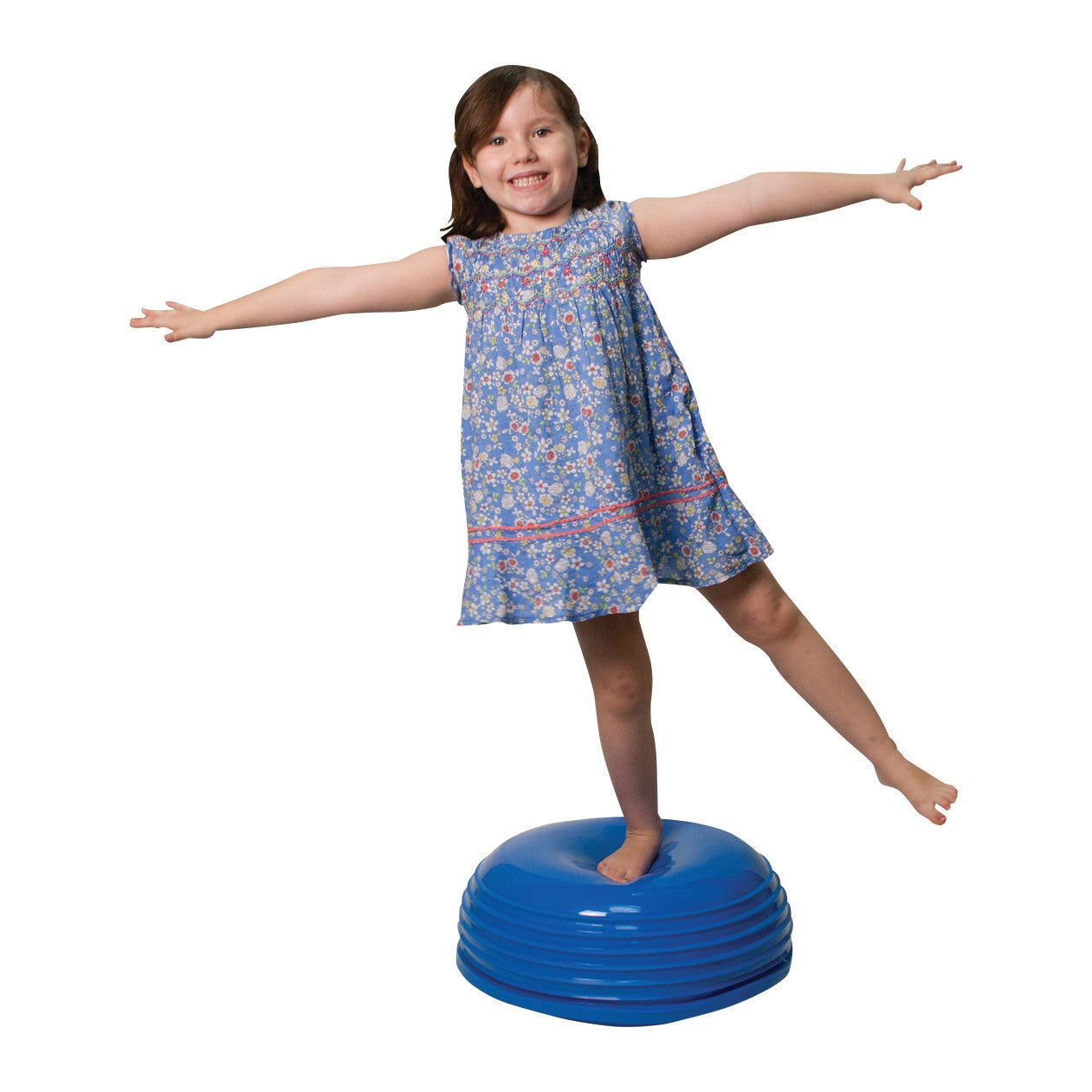 A child balances on a CanDo Wobble Ball, a blue inflatable disc, with arms outstretched wearing a blue floral dress.
