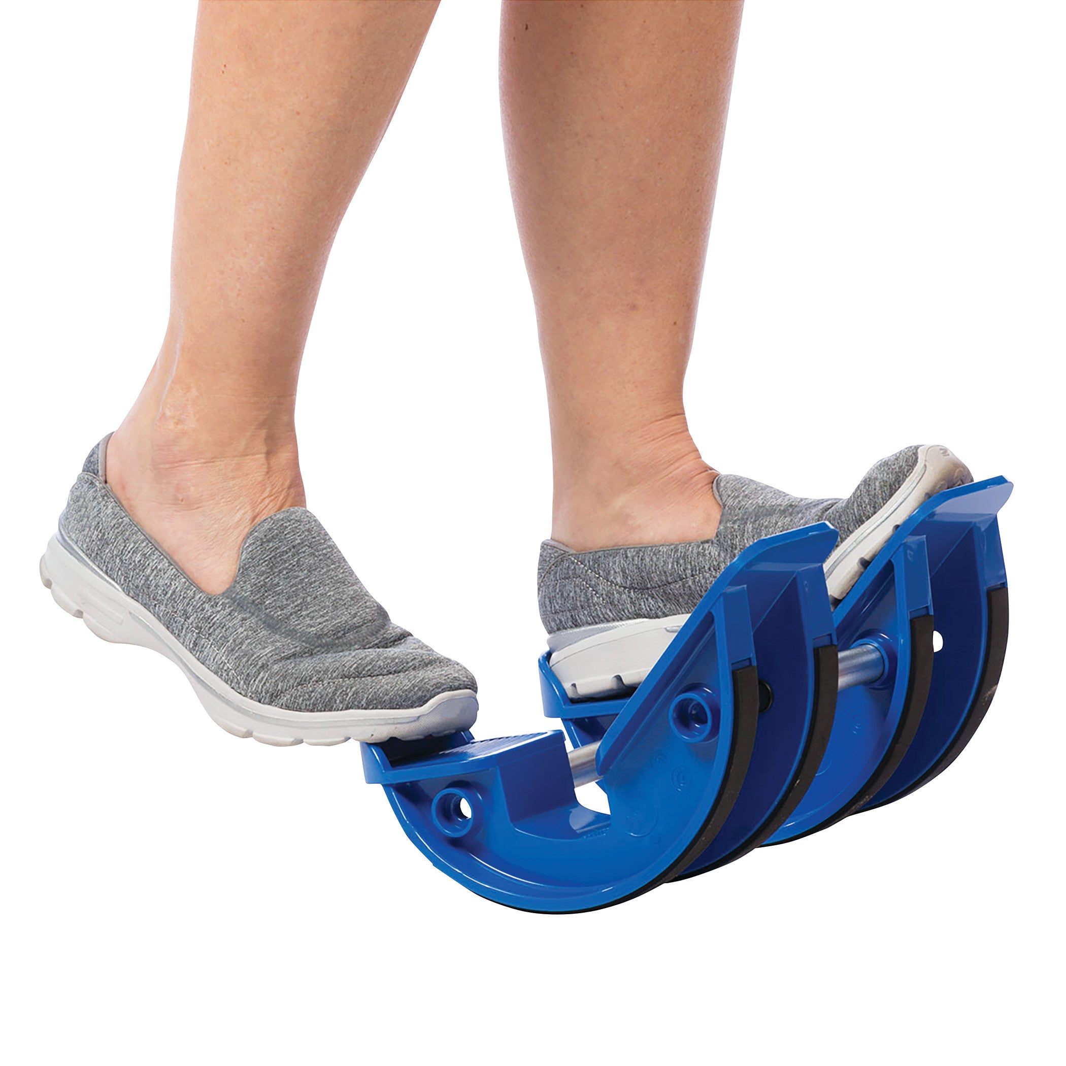 A person uses the Medi-Dyne ProStretch Calf and Foot Stretcher to stretch their calves while wearing gray slip-on shoes.