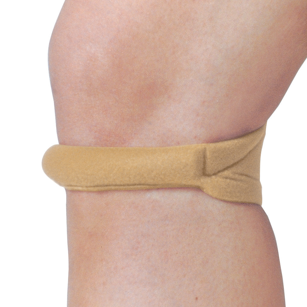 A Cho-Pat Knee Strap is wrapped around the knee, providing support and compression to the area just below the kneecap.