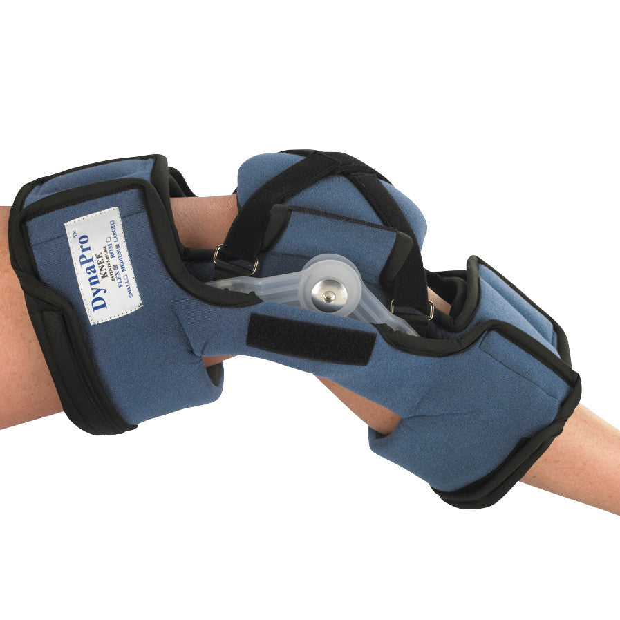 An arm wearing the OCSI DynaPro Flex Knee Orthosis, a blue padded brace with adjustable straps and a hinge mechanism.