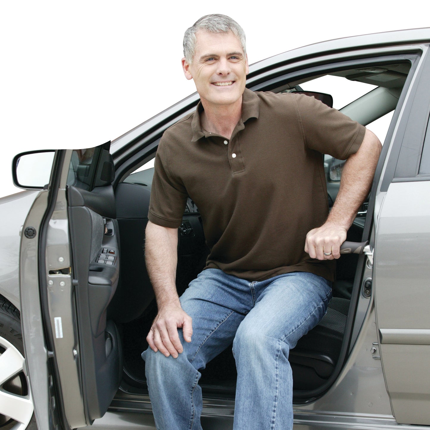 A man uses the Metro Car Handle Plus for support while exiting a car. The handle is inserted into the car door latch.