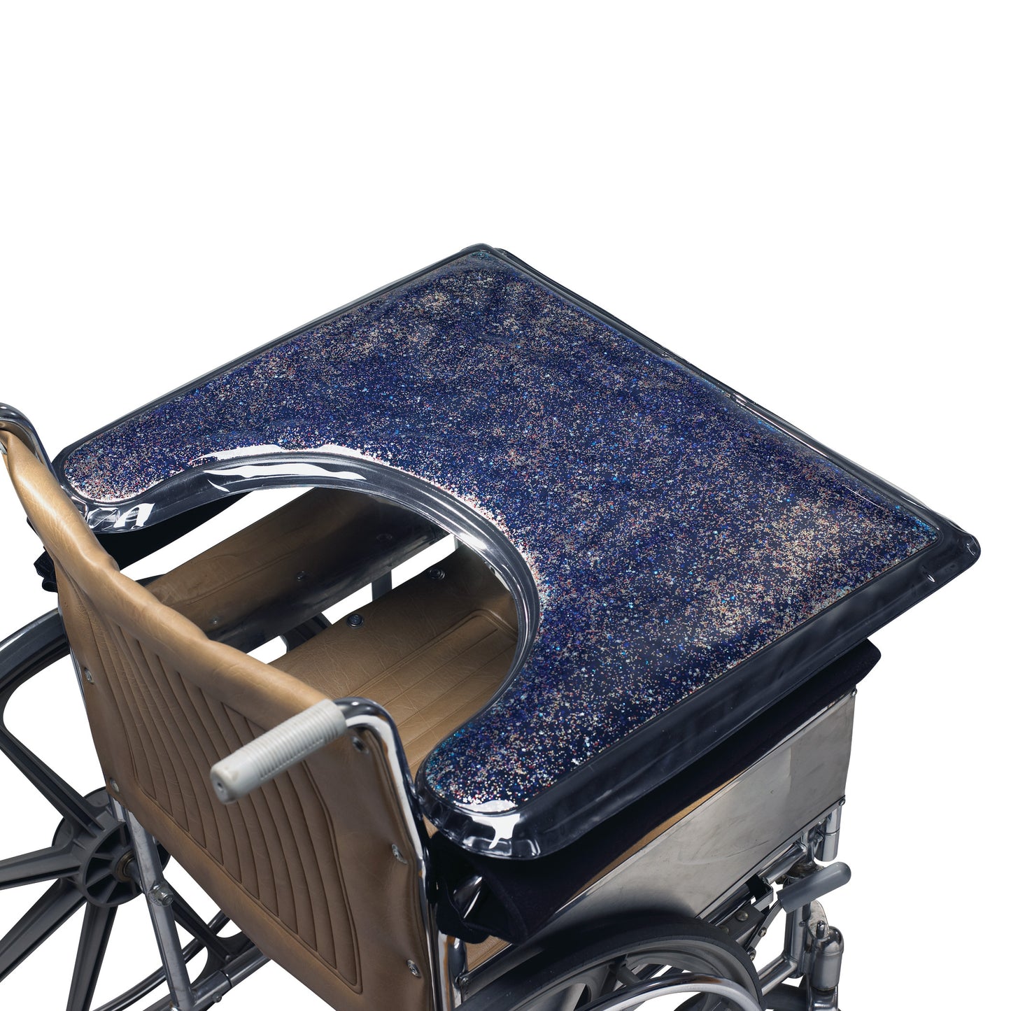 A wheelchair features the SkiL-Care Lift-Away Gel-Top Sensory Stimulation Tray with a glittery, blue gel surface for sensory stimulation.