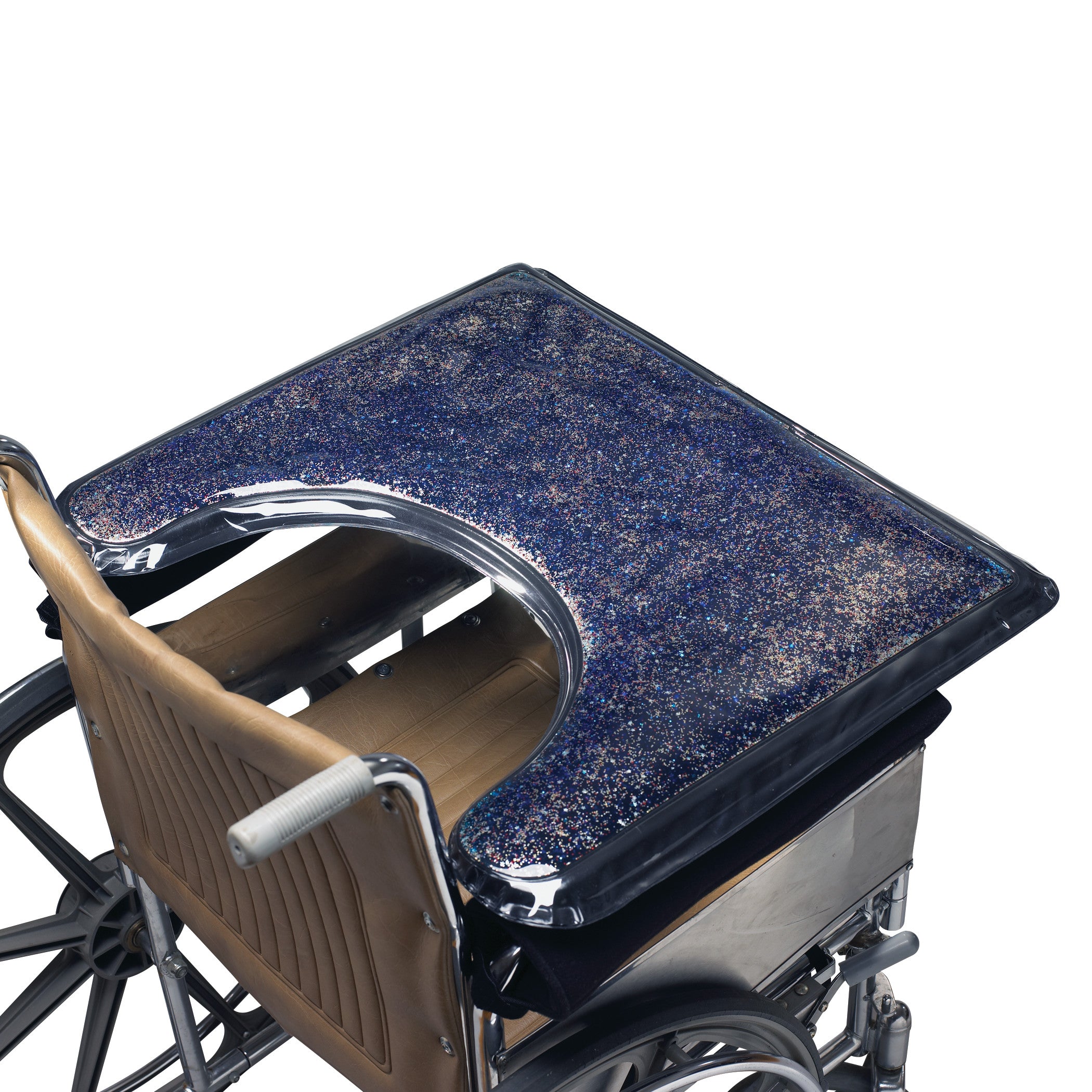 A wheelchair features the SkiL-Care Lift-Away Gel-Top Sensory Stimulation Tray with a glittery, blue gel surface for sensory stimulation.